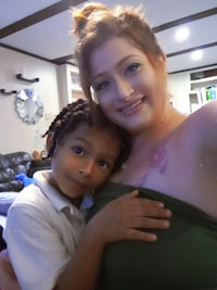 a woman is posing for a photo with a child